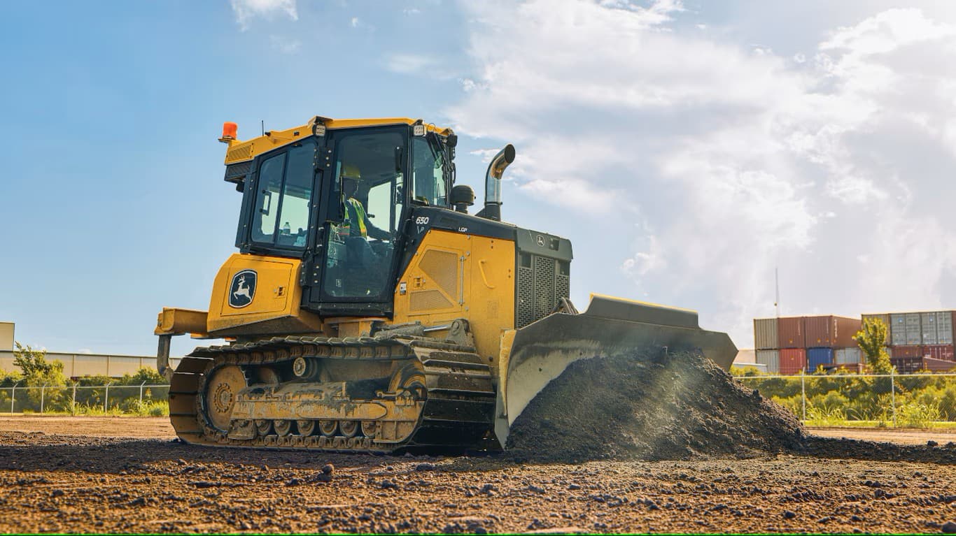 A dozer grading fill dirt on a job site